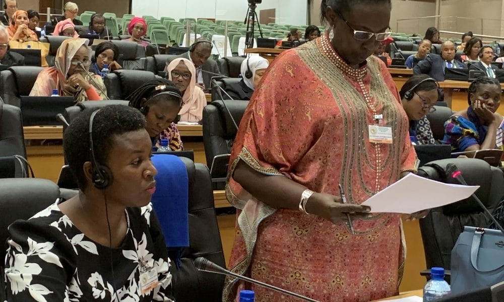 Hon. Robina Rwakoojo makes a contribution during the PAP Conference on womens rights in Midrand South Africa. To her right is Hon. Justine Khainza e1571255451927