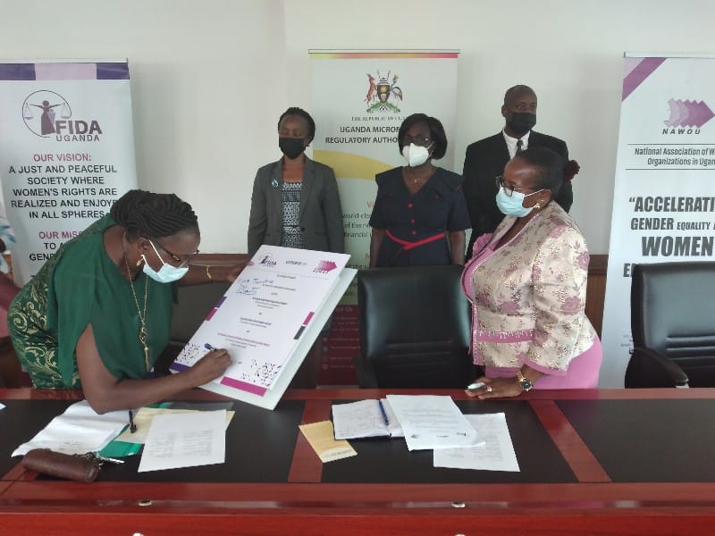 Ms Edith Tusubira UMRA ED signing the document 1